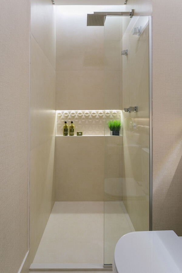 banheiro bege com revestimento 3d na parede do chuveiro