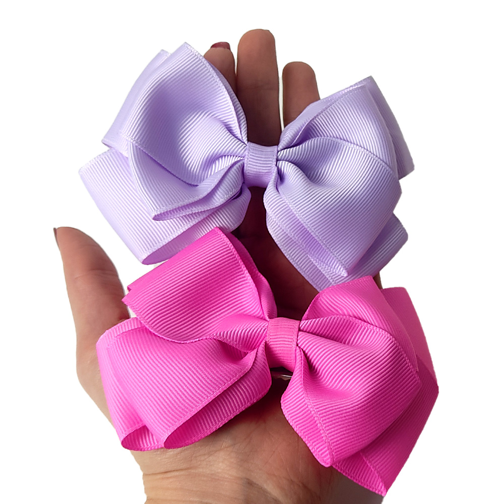 laços de cabelo infantil temáticos vs. laços de luxo